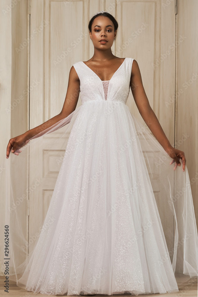 Fototapeta premium Young Bride Standing by Window Smiling