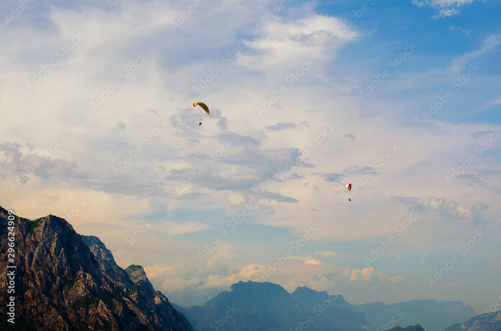 Paragliding in the mountains on blue sky background Paragliding in the mountains on blue sky background