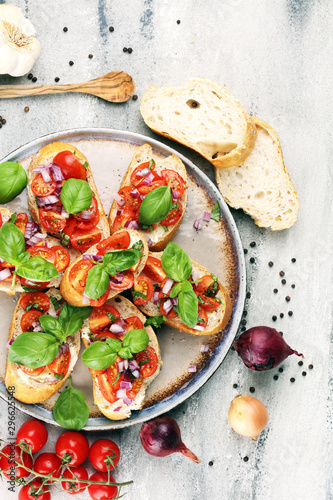 fresh tomato bruschetta. italian food appetizer with basil on table