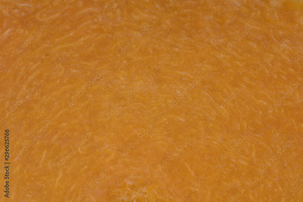 Yellow pumpkin cut in half with the texture of pulp. Pumpkin slices background closeup, top view Yellow pumpkin cut in half with the texture of pulp. Pumpkin slices background closeup, top view