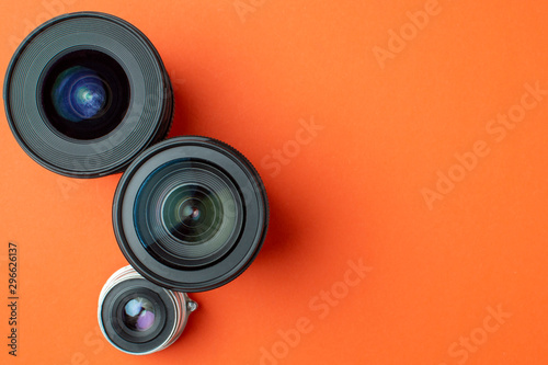 Progress of different photo lenses on a colored background  a set of old and modern photo devices for the camera