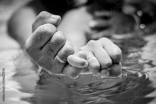 hands of man and woman in water photo