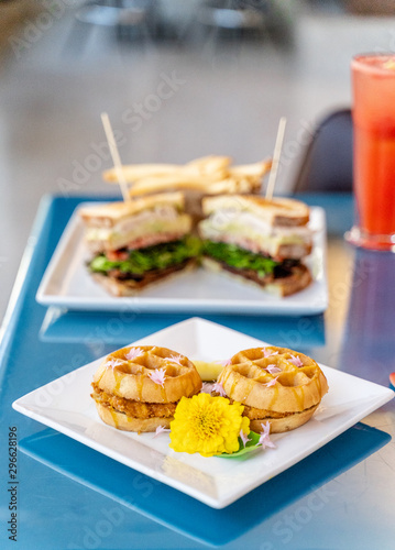 Chicken and waffle slider sandwich. An inventive take on a southern classic served in an upscale restaurant for brunch or breakfast. 