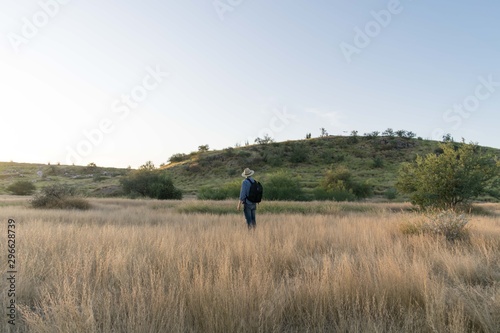 Standing man in natural environment at a sunny afternoon