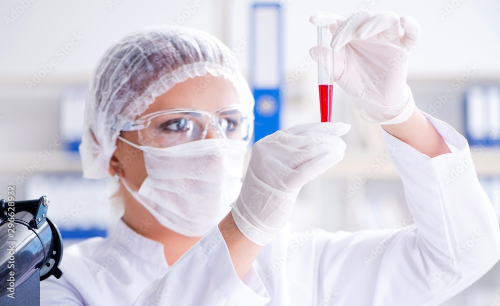 Female scientist researcher conducting an experiment in a labora Female scientist researcher conducting an experiment in a labora