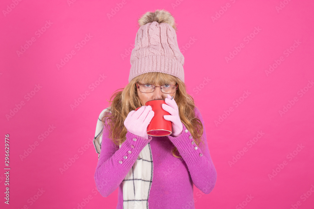 adult woman with cup of coffee or warm infusion isolated on color background