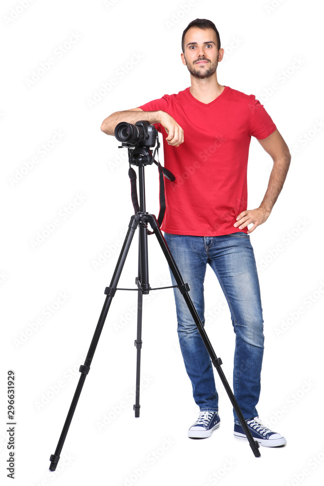 Young photographer with camera on tripod isolated on white background
