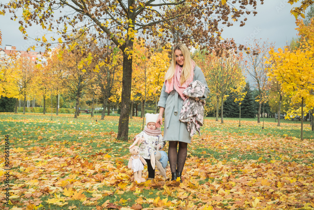Happy mother and little daughter at autumn park Happy mother and little daughter at autumn park