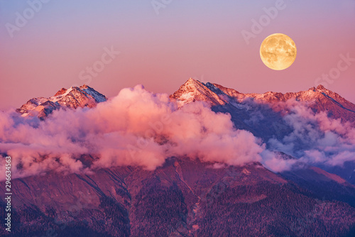 Moonrise above Caucasus mountains at evening time. Russia.