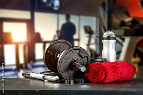 Fototapeta Naklejka Na Ścianę i Meble -  Dumbbell, barbell and workout in the gym. Space for products and decorations or text with blurred gym background.