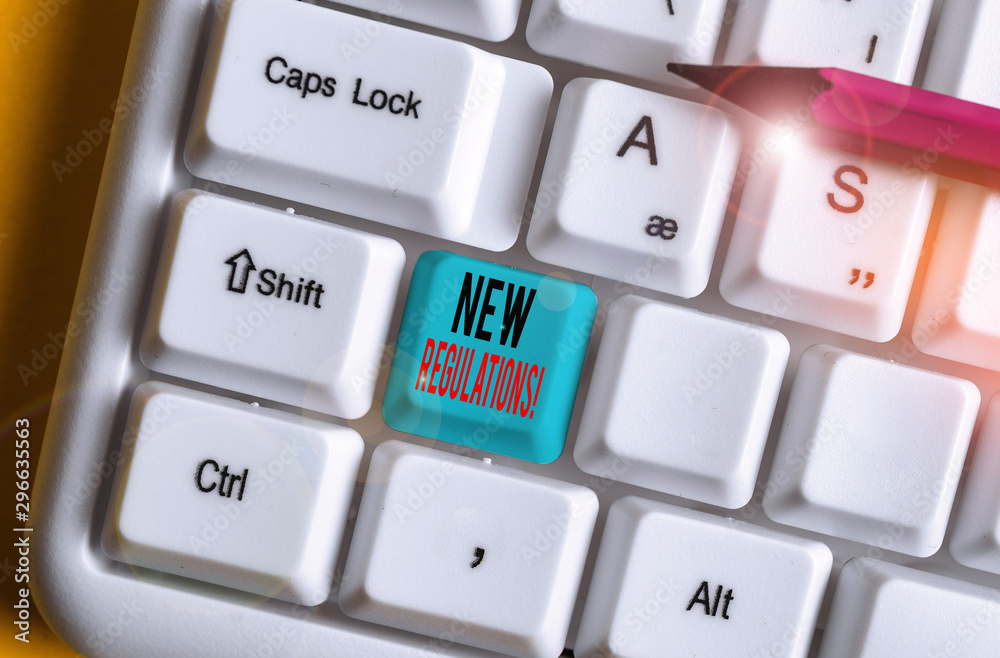 Conceptual hand writing showing New Regulations. Concept meaning rules made government order control something done White pc keyboard with note paper above the white background