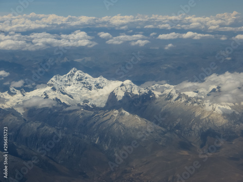 Magestuosa aerial view of large snowy mountains, with glacier, a sunny day with some clouds photo