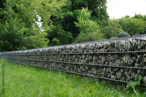 An effective, quick to install wall made of gabions. In the park.