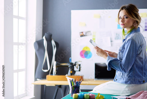 Fashion designer woman working on her designs in the studio photo