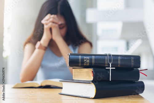 Cross on holy bible on table with background Women praying hand faith jesus promise Pray for god blessing