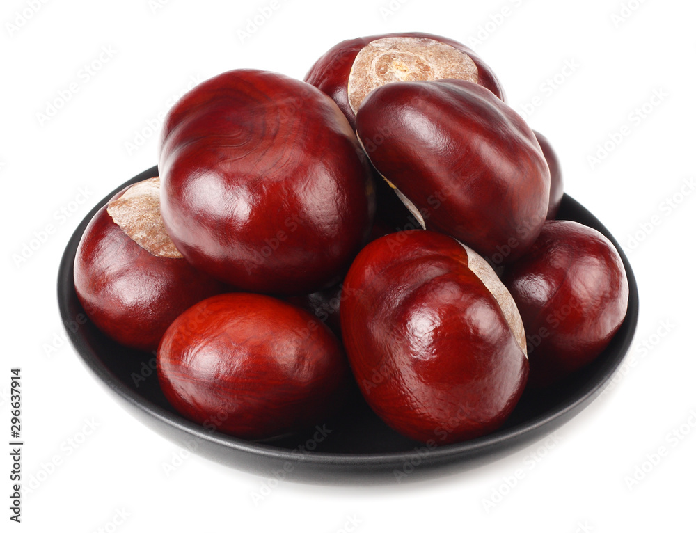 chestnuts in a black plate isolated on white background chestnuts in a black plate isolated on white background