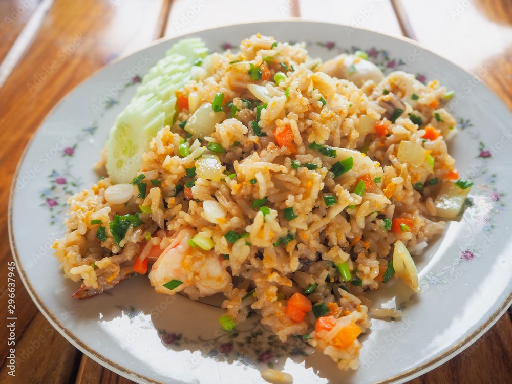 Thai food fried rice egg with cucumber carrot shrimp Sliced spring onion in dish yummy for healthy. Thai food fried rice egg with cucumber carrot shrimp Sliced spring onion in dish yummy for healthy.