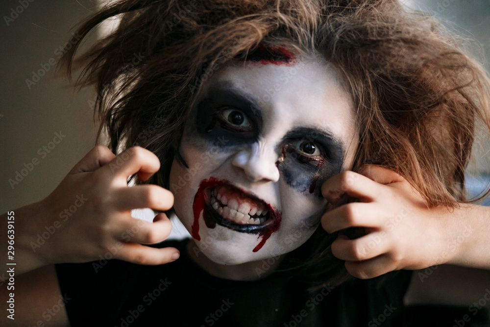 Children in carnival costumes with scary face painting on Halloween. Black  background. Stock Photo