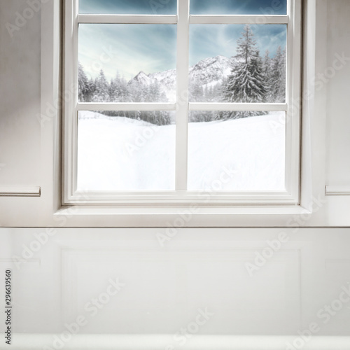 Snowy winter outside the window background with space on wooden board top for products and decorations. Christmas decorations.