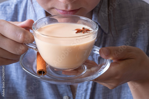 Wallpaper Mural Young caucasian woman enjoing a cup og masala chai tea Torontodigital.ca