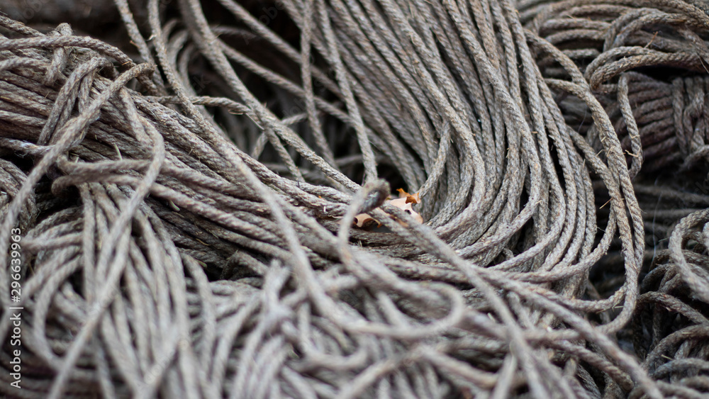 Rough Cord made from natural plant fiber. Rope detail, closeup. Horizontal. Grey tone. Copy space. Wallpaper and background about fabtic manufacture, eco friendly material. Banner