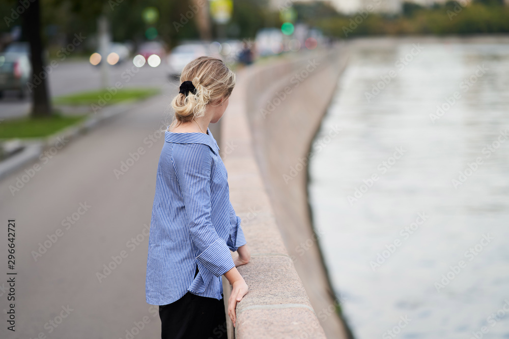 Fototapeta premium Moscow, Russia - August 09, 2019: A girl walks along the embankment of Moscow