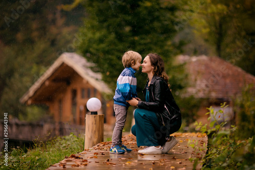 happy family, mother and son outdoors in autumn in the pouring rain, Rosa Khutor, Sochi, October 2019