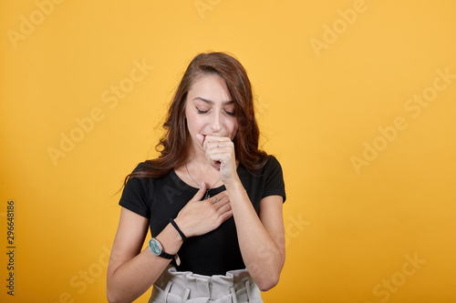 Cute teen couging shows having problems with her throat. She is going to be sick as she is feeling pain in her throat.