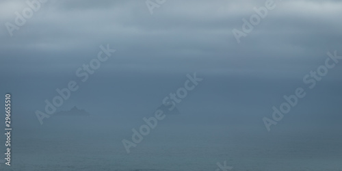 a viewpoint from bray head on valentia island in the ring of kerry in the south west coast of ireland during an autumn sunset showing the skellig islands and watchtower