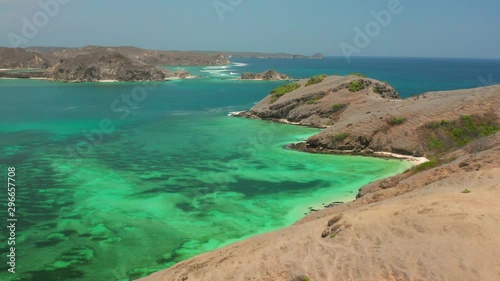 The white sand beach of Tanjung Aan in Lombok, Indonesia during a sunny day. Aerial shot. photo