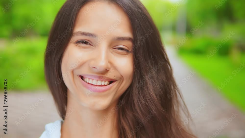 caucasian model posing look to the camera portrait happiness brunette on the street summer city park with bright green nature caucasian model posing look to the camera portrait happiness brunette on the street summer city park with bright green nature