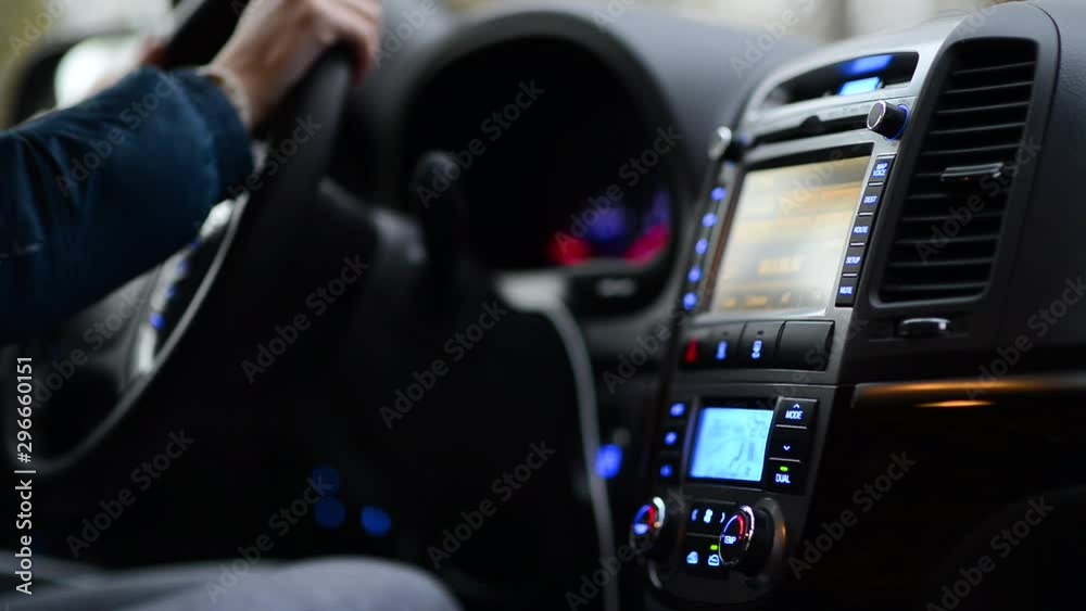 woman distracted from driving in order to adjust the air conditioning system woman distracted from driving in order to adjust the air conditioning system