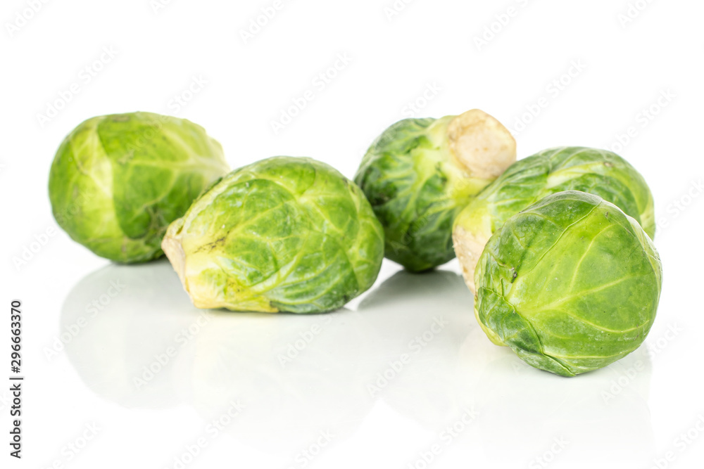 Group of four whole fresh green brussels sprout heap isolated on white background Group of four whole fresh green brussels sprout heap isolated on white background