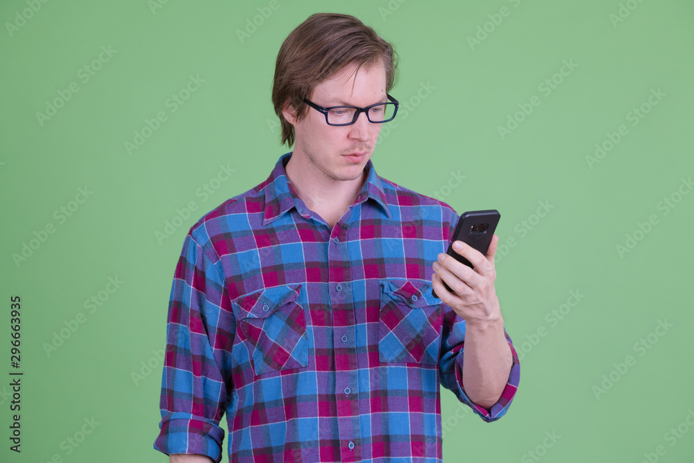 Young handsome hipster man with eyeglasses using phone Young handsome hipster man with eyeglasses using phone