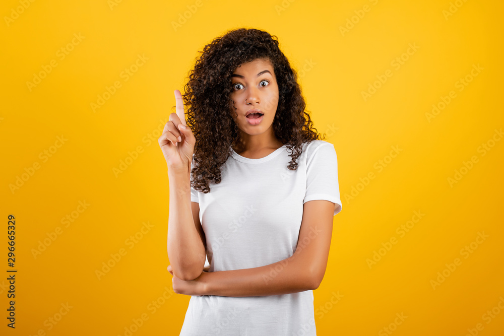 excited black woman having an idea pointing finger up isolated over yellow excited black woman having an idea pointing finger up isolated over yellow