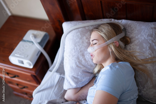 Obraz na płótnie Sleep Apnea - sleeping on side with cpap machine