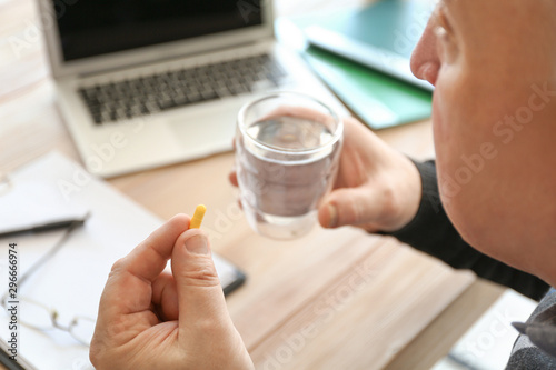 Elderly man taking medicine...