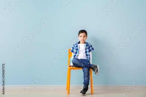 Cute fashionable boy sittin...