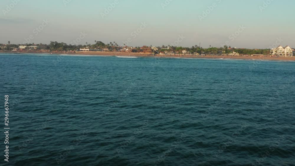 The beaches of Canggu during sunset. With beach clubs, hotels, resorts, restaurants and surfers. Aerial shot. The beaches of Canggu during sunset. With beach clubs, hotels, resorts, restaurants and surfers. Aerial shot.