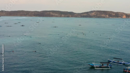 Surfing at sunset at the surf spot Don Don in Gerupuk, Lombok. Aerial shot. photo