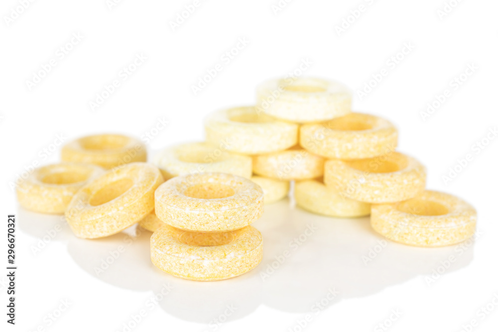Lot of whole folded round pale yellow candy isolated on white background Lot of whole folded round pale yellow candy isolated on white background