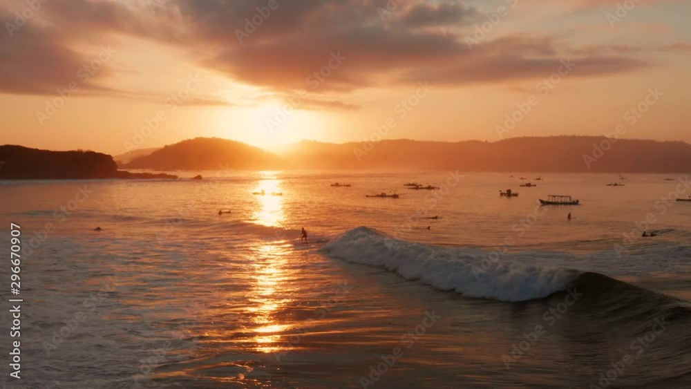 Sunrise at the surf spots of Gerupuk in Lombok, with a view on the bay with the fishing boats and surfers. Aerial shot. Sunrise at the surf spots of Gerupuk in Lombok, with a view on the bay with the fishing boats and surfers. Aerial shot.