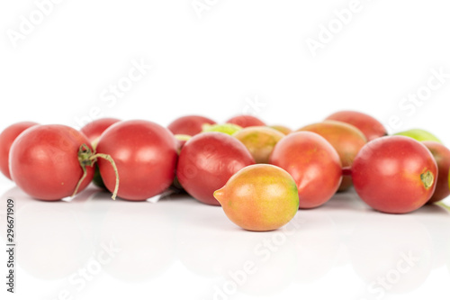 Lot of whole fresh tomato de barao isolated on white background photo