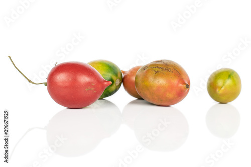 Group of five whole fresh tomato de barao isolated on white background photo