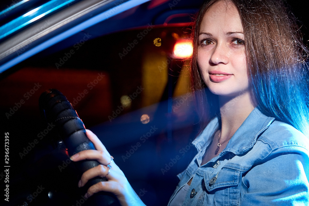 Beautiful young woman in the car at night Beautiful young woman in the car at night