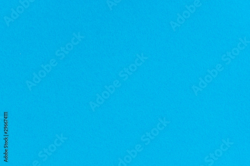 Blue color paper background. Empty space on monochrome cardboard