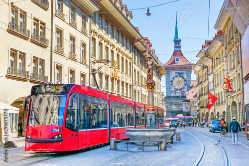 Streets with shopping area and Zytglogge astronomical clock tower and fountain in the historic old medieval city centre of Bern, Switzerland