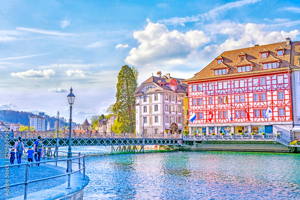 View on the beautiful picturesque historic buildings with cafe and restaurants from the embankment of Reuss River in old town of Lucerne, Switzerland
