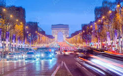 Arch of Triumph and Champs Elysees in Paris at night, France © MarinadeArt