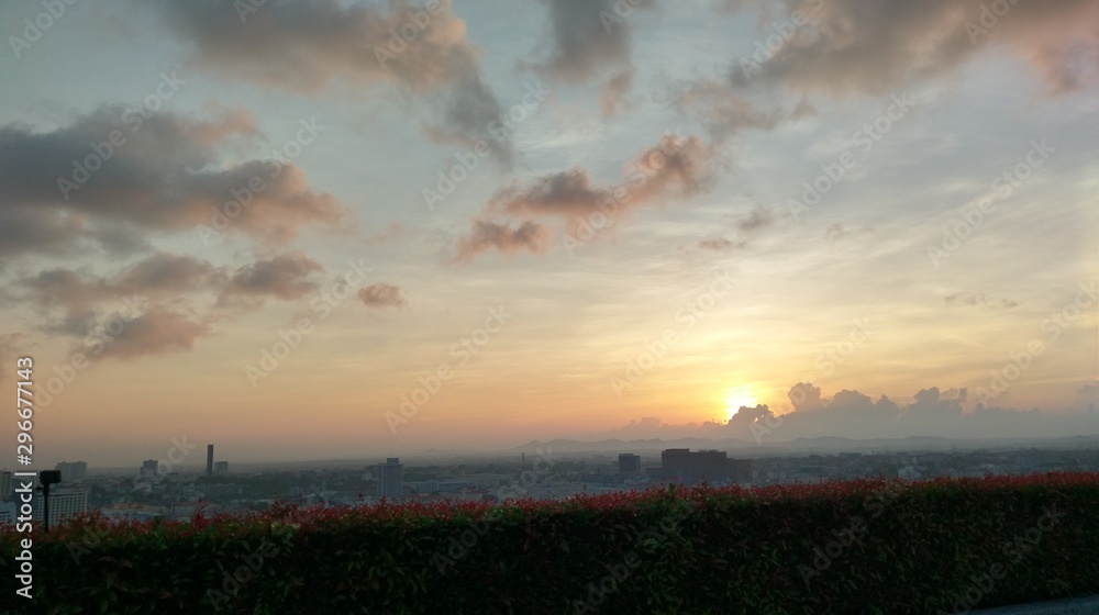 Fototapeta premium sunrise slowly rise up , hidden by the cloud